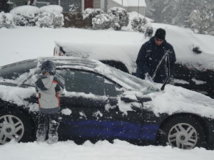 man and son looking at their car