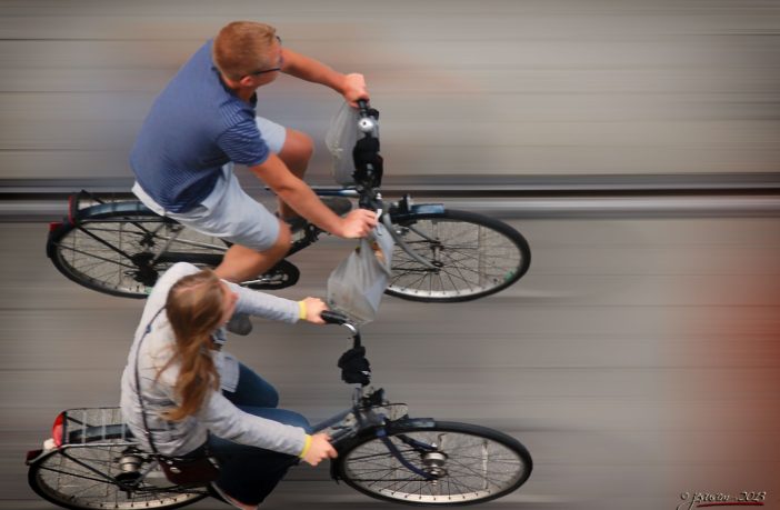 Two people on e-bikes