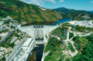 w Energy Storage System for Tâmega River The Tâmega River flows from its source in Spain, through to Portugal where it discharges into the Atlantic Ocean. Along the way it passes through ancient settlements, but also through deep narrows between mountains ideal for dams. A new energy storage system is commissioning in the Portuguese mountains, with capacity equivalent to a mega battery. The New Tâmega Energy Storage System The Portuguese government approved a new energy storage system comprising three new hydroelectric schemes along the Tâmega River in 2014. The first of these, namely the Alto Tâmega concrete double curvature arch dam, has begun generating electricity. Wikipedia confirms the following statistics: The electrical heart of the pioneering Alto Tâmega dam, comprises two 80 megawatt turbine generating units. Their maximum flow rate is 200 cubic meters-a-second, producing 139-gigawatt-hours of electricity a year. Two lateral spillways with total discharge capacity of 1,825 cubic-meters-a-second, prevent the dam over-flowing. More Information About Alto Tâmega Dam The Financial Times published more information ‘on the ground, after contributor Barney Jopson investigated the site. He describes the sound of the 230-ton water pump as a ‘roaring hum’, as it sends water four miles up the mountain to a ‘water battery, where the energy stores. The new energy storage system at Tâmega high up in the Portuguese mountains takes surplus energy from the grid. And then uses this resource to lift the water to a smaller dam higher. And then, when the grid is hungry during peak, it release the energy to the pumps-become generators, so it becomes electricity again. This energy is enough to charge 400,000 electric vehicle batteries, or sustain 2.4 million homes for a full day according to Financial Times.