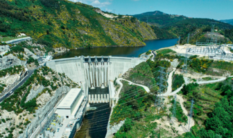 w Energy Storage System for Tâmega River The Tâmega River flows from its source in Spain, through to Portugal where it discharges into the Atlantic Ocean. Along the way it passes through ancient settlements, but also through deep narrows between mountains ideal for dams. A new energy storage system is commissioning in the Portuguese mountains, with capacity equivalent to a mega battery. The New Tâmega Energy Storage System The Portuguese government approved a new energy storage system comprising three new hydroelectric schemes along the Tâmega River in 2014. The first of these, namely the Alto Tâmega concrete double curvature arch dam, has begun generating electricity. Wikipedia confirms the following statistics: The electrical heart of the pioneering Alto Tâmega dam, comprises two 80 megawatt turbine generating units. Their maximum flow rate is 200 cubic meters-a-second, producing 139-gigawatt-hours of electricity a year. Two lateral spillways with total discharge capacity of 1,825 cubic-meters-a-second, prevent the dam over-flowing. More Information About Alto Tâmega Dam The Financial Times published more information ‘on the ground, after contributor Barney Jopson investigated the site. He describes the sound of the 230-ton water pump as a ‘roaring hum’, as it sends water four miles up the mountain to a ‘water battery, where the energy stores. The new energy storage system at Tâmega high up in the Portuguese mountains takes surplus energy from the grid. And then uses this resource to lift the water to a smaller dam higher. And then, when the grid is hungry during peak, it release the energy to the pumps-become generators, so it becomes electricity again. This energy is enough to charge 400,000 electric vehicle batteries, or sustain 2.4 million homes for a full day according to Financial Times.